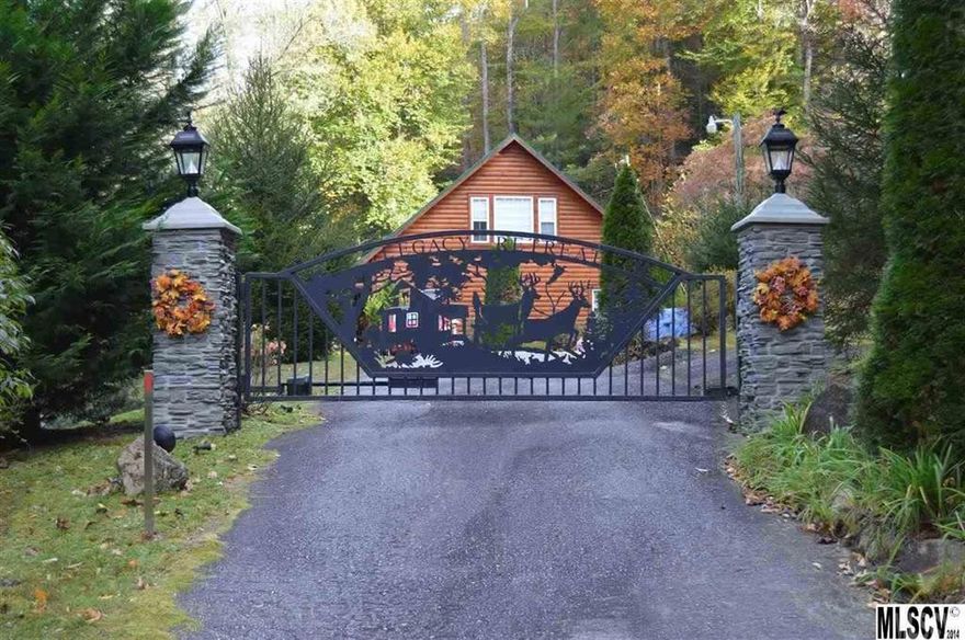 Natural beauty surrounds this gorgeous NC mountain home with water views. Of stunning Western Pine construction, this 3 bedroom, 3 bathroom home is positioned on a sprawling 1.23 acre lot located within minutes to wildlife game lands and the Trout stocked Buffalo Creek. This home boasts an expansive main level that features a living room w/built-in bookcases and gas-log fireplace, spacious kitchen w/updated cabinetry, stainless appliances, large pantry/laundry  and tile flooring, and master suite with en-suite bathroom.  A second bedroom and office/third bedroom finish off the main level space.  The second level of the home offers a den, second kitchen space, and second master bedroom w/en-suite bathroom and walk-in closet. Observe wildlife from the comfort of an expansive front porch w/custom fixtures and ceiling fans. Large 12x20 storage building offers additional storage space. Security system and gated entrance to home.  Being sold "AS IS".  Seller will make no repairs.