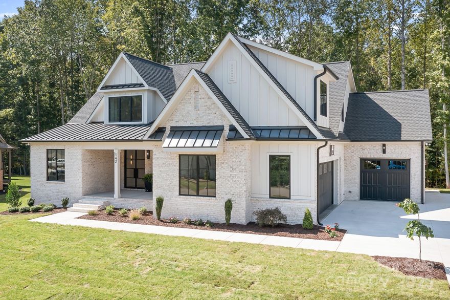 Gorgeous Brick home less than 3 miles to Downtown Davidson! Nestled back in the best neighborood around- Davidson Downes, our Hidden Gem! Deeded Off-site septic allows room for a pool in this level, private, semi-wooded back yard! Fantastic Open floor plan w/ Andersen 400 series casement windows and sliders, Contemporary Iron double front doors. Gorgeous 8" white oak engineered wood floors, Beautiful Quartz countertops, Kitchen features an oversized island, Monogram 48" gas range/double oven and DW, Large walk in Butler's pantry w/ cabinetry and shelving/microwave. Custom cabinetry w/Built ins in family room, 12' coffered ceilings and quadruple sliders opening to the screened porch. Primary bedroom on Main floor with coffered ceilings and extensive trim work and zoned HVAC. Zero entry shower in Primary bath, white oak cabinetry, heated towel bar, upgraded tile throughout the home!  ENORMOUS walk in primary closet leads to both laundry room and master bath. Tankless recirculating water heater. 4 BR/3.5 bath. 3 car oversized garages with ultra quiet Jackshaft openers, large front porch, huge screened porch and bricked concrete patio perfect for outdoor living. Main floor office with french doors. Large Bonus room.  235 SF unheated walk in attic storage off BR2! Pull down attic stairs in Garage 3. Lot 159 is a Premium lot!! In-ground Irrigation, Private well with 20 gpm. Sealed Crawl Space. This home has High-end finishes, Excellent Craftsmanship and Quality throughout! Low HOA, Neighborhood park, Great Schools, Low Iredell County Taxes. Home completed September 2025!