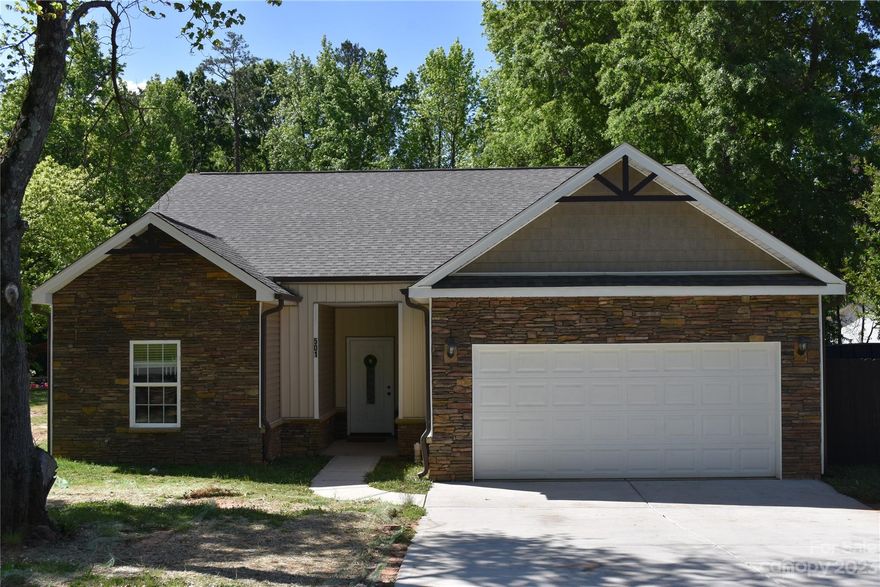 This stunning one and a half story residence is nestled in the Austin Park subdivision in Hidden Valley in the UNCC area of Charlotte, NC. Home boasts an inviting open floor plan featuring a beautiful kitchen adorned w/granite countertops, custom cabinets, tile backsplash, electric cooktop & beautiful stone bar that separates the Kitchen from the Dining Room. Start your day with a cup of coffee in the sunlit dining area or outside on the concrete patio. Home features a spacious living room that connects to the Kitchen & Dining that has gorgeous molding & wainscoting. Upstairs is a loft area, 2 BRs w/walk-in closets & a luxurious Bath. Attic. Two secondary bedrooms & full bath complete the Main Level where the generously proportioned Primary Bedroom & Bath are located. Primary BR has tray ceiling, walk-in closet; BA has tile, granite, 2 sinks, whirlpool tub, sep. shower. The home has 5 BR, 3 BA. Beautiful moldings, HW floors, 9' ceilings, recessed lighting, elegant archways, HW stairs.