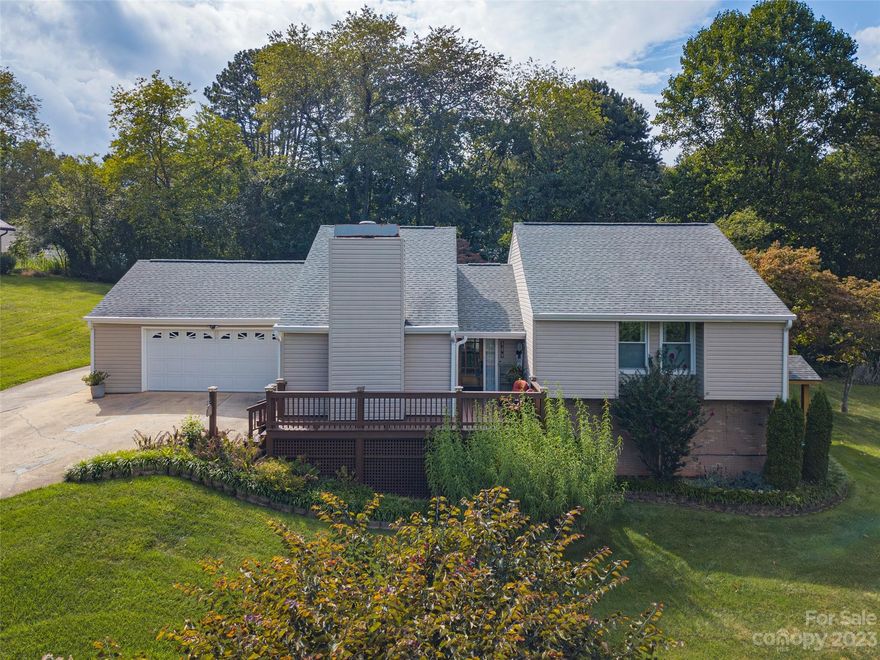 Ready to move in? Surrounded by lovely barns and pastures in the established neighborhood of Dogwood Acres this renovated split level house is waiting for you. The newly installed engineered wood flooring, neutral walls, modern interior doors, and updated kitchen welcome you. The floor plan is great for entertaining.  Renovated 10 year ago, the kitchen is finished with rich wood cabinets, silestone counter tops, stainless steel appliances, a baking island and breakfast bar. The vaulted ceiling, long windows and gas log fireplace with brick surround enhance the living room. Up just three stairs you will find the primary suite finished with a West Shore Homes walk in shower and a walk in closet and two guest bedrooms that share a hall bath. Downstairs you will find a hobby/storage room and cozy den with third bath that lead outside to the side yard & cedar portico. Your fur friends will love the spacious fenced backyard.  You are just a quick 20-25 min drive to Asheville.