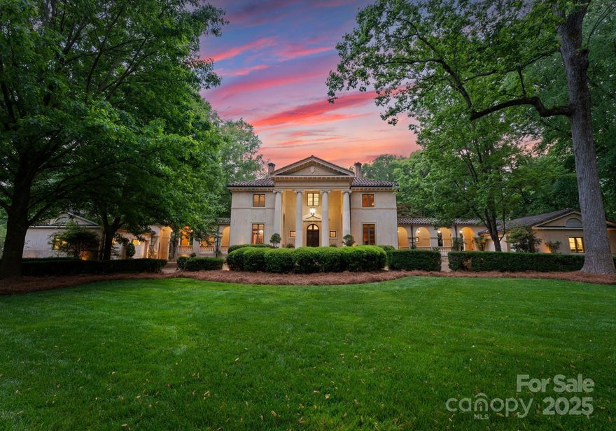 Set on a 1.37-acre wooded lot in the highly desirable Pellyn Wood, Villa Katrina at 5030 Hardison Road is a striking example of Palladian architecture, defined by classical symmetry, Venetian stucco, Italian limestone, and a 40-foot domed atrium crowned by a stained-glass skylight. A curved gravel driveway leads to the elevated homesite, where arcades connect the main residence to two separate two-car garages flanking the structure. Inside, the expansive primary suite offers a luxurious retreat with a spacious bedroom, elegant sitting room, opulent bathroom, dressing area, and generous walk-in closet. Additional features include a walnut-paneled library, gourmet kitchen, and a finished lower level with a media room, exercise room, bonus room, wet bar, and climate-controlled wine cellar. Located near top-tier schools, this custom-designed estate offers refined living in one of Charlotte’s most prestigious neighborhoods. This is Charlotte's one & only true Italian Palladian work of art.