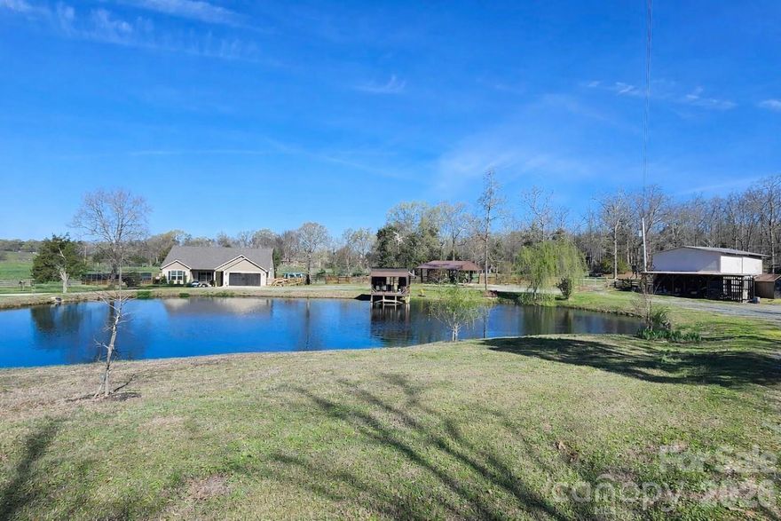 If you’ve been dreaming of your own hobby farm in the country, then this is it! Exceptionally well maintained, this one-of-a-kind property sits on 8 (+/-) acres and offers the ideal setup. The land is fully fenced and ready for animals, featuring a 2-stall barn with paddock area and open pasture. A stocked pond with aerator adds to the setting, where you can enjoy quiet mornings in the pier house overlooking the water.

Built in 2021, the low-maintenance one-story home offers 3 bedrooms and 2 full baths with an open floor plan and split-bedroom design. A welcoming covered front porch sets the tone, perfect for rocking chairs and morning coffee. Inside, the functional kitchen features a center island, beautiful cabinetry, and a soaring cathedral ceiling that enhances the spacious main living area. The oversized primary suite provides a comfortable retreat with a walk-in closet and plenty of room to unwind. The attached 2-car garage is fully insulated and upgraded with an epoxy floor and mini-split system.

Designed for outdoor enjoyment, the 52-foot covered rear porch includes an epoxy floor and built-in awnings for shade and weather protection—ideal for entertaining or relaxing year-round. A 24-foot saltwater above-ground pool offers the perfect place to cool off during the warmer months.

Additional structures provide exceptional versatility and storage, including a 2-story workshop with 220 electrical hookup, pole barn, open car shed, metal carport, and chicken coop—offering ample space for equipment, hobbies, and more.

Surrounded by a variety of mature and thoughtfully planted trees, this property offers a private, peaceful setting with endless possibilities.  *PICTURES COMING 4/18*