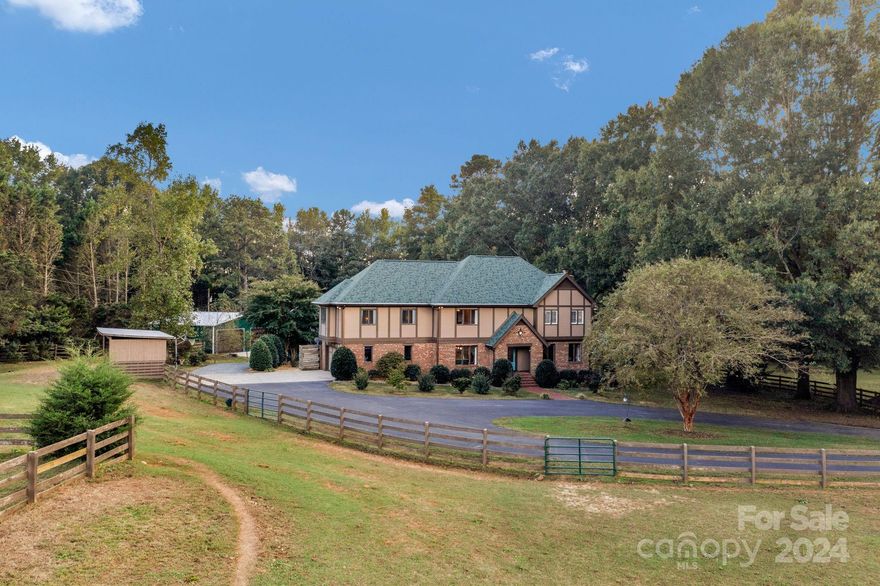 Incredible, picturesque 7.2-acre horse farm w/in-ground saltwater pool/spa & highly rated Weddington schools! Beautiful Tudor-style home w/updated kitchen & baths. Gorgeous wood floors, charming stone fireplace & 14-foot kitchen island create a warm & inviting space perfect for entertaining. The private bonus/bedroom & full bath over the garage is ideal for guests or as a 2nd primary. The extensive equestrian facilities including 2 fenced pastures, foaling stalls, 2 paddocks, a riding ring, 2 run-in sheds & a barn w/3 stalls, wash bay & storage make it an ideal property for horse enthusiasts. The detached 5+car & RV garages & large shed add great value, providing ample storage & space for vehicles & hobbies. It's location near highly regarded Antioch elementary school, as well as access to walking trails & nearby shopping & dining, enhances its appeal for those looking for a tranquil, yet convenient lifestyle. 3rd Full bath in bonus/bedroom was added by sellers, but not permitted.