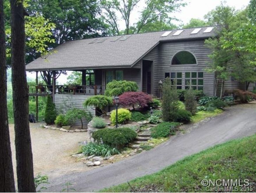Custom contemporary made for entertaining with views for miles! Home features covered wrap-arounddeck, vaulted ceiling in open kitchen/living, master on main & hardwood floors throughout. Kitchen boasts granite counters, two islands with a breakfast bar & cabinets galore!Listen to the outdoor water feature while relaxing in the hot tub. Hike to Mt Mitchell, Pisgah National Forest borders the property.Additional adjacent property available.