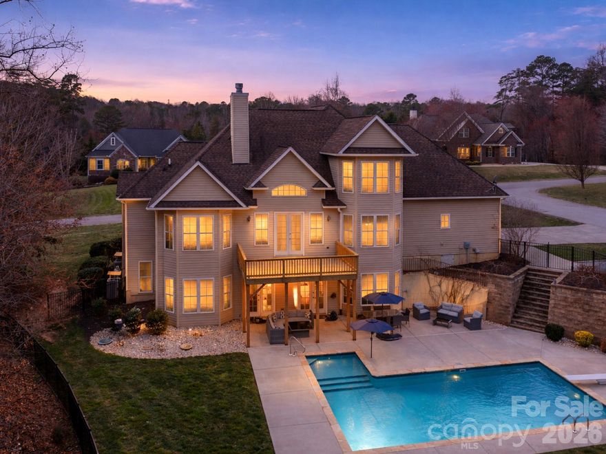 A rare opportunity to own a home that combines flexible multi-generational space with secondary living quarters, a private backyard pool retreat,  and perfectly positioned in a desirable Troutman location near Lake Norman and Lake Norman State Park.
This is an original custom-built home designed for flexible living and entertaining. The finished walk-out basement functions as its own living space, featuring a large recreation room with projector screen wall, a second kitchen, full bathroom, exercise room, and additional flex room that could be used as a bedroom, teen suite or office. This level features extensive storage areas too. French doors lead directly to the pool patio, making this level ideal  for pool days. Whether it’s guests, extended family, or multi-generational living you need this home offers it all.
Stepping outside you find a  16' x 33' in-ground saltwater pool with tanning ledge and diving board, bordered by Tennessee rock. The backyard is tree-lined for added privacy thanks to nature.. The sundeck was rebuilt in 2025, creating the perfect setting for outdoor entertaining and summer gatherings. The fenced yard also includes a wired storage building .  There is also an overflow parking pad that is perfect for boats, recreation vehicles or just more cars.
Inside, the main level features natural wood floors, granite countertops, honey-maple cabinetry in the main kitchen, and a bay-window breakfast room overlooking the pool. The spacious primary suite includes a tray ceiling, bay sitting area, two walk-in closets, jetted tub, double vanities, and walk-in shower with dual shower heads. A second bedroom on the main level offers flexibility for guests, nursery, or office space. A main level primary suite and a secondary bedroom on this level is super hard to find!
Upstairs you’ll find two additional bedrooms, an enormous bonus room with eave storage. New carpet installed in 2026 in all carpeted spaces.  This home has so much storage you won't ever run out of space  for anything!
Additional features include a  water filtration system, garage heater, 220 outlet service in garage that is 30 amp with a 50 amp outlet. Located in a neighborhood with covenants in place but no HOA dues at this time, and just minutes from Lake Norman State Park, Lake Norman boating access, Troutman, and Mooresville amenities. Less than 5 minutes to Duke Power State Park for days on the lake!  Convenient to Mooresville too for shopping.   I-77 and I-40 are also convenient no matter where work or play may take you.   This one has everything you need.