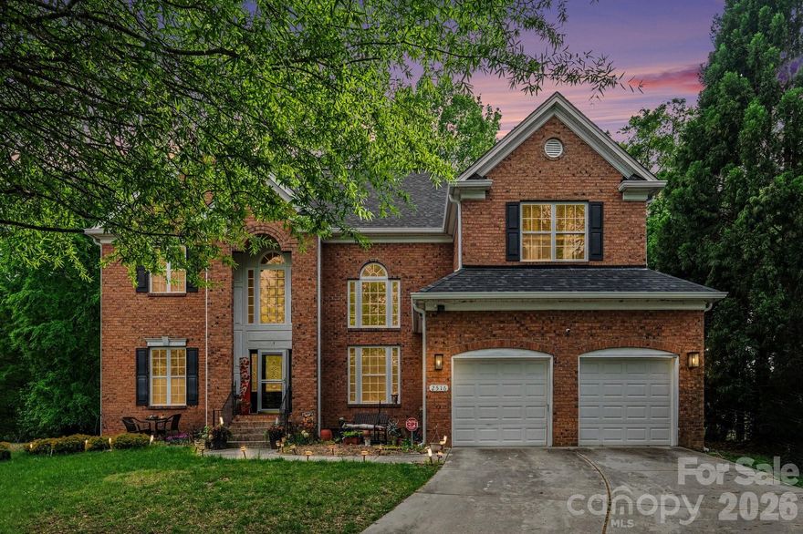 Nice full-brick estate situated in the highly sought-after River Oaks community of Waxhaw. This home makes a grand first impression with its stately curb appeal, professional landscaping, and a side-load two-car garage. Step through the arched entry into a soaring two-story foyer featuring hardwood floors that set the tone for the rest of the residence. The main level is designed for both sophisticated entertaining and comfortable daily living. The impressive great room is anchored by a cozy gas fireplace with a custom mantel, flanked by built-in cabinetry, and illuminated by a dramatic wall of floor-to-ceiling windows that bring the beauty of the outdoors inside. The dining room offers an elegant atmosphere with a deep tray ceiling and heavy crown molding, while the adjacent formal living room features sophisticated picture frame wainscoting. The chef’s kitchen serves as the heart of the home, boasting granite countertops, a center island with breakfast bar seating, stainless steel appliances, and a classic tile backsplash. The bright breakfast nook offers a sunny spot for morning coffee and provides seamless access to the expansive outdoor living space. The upper level is home to a large primary suite that serves as a true sanctuary, complete with a double tray ceiling and a massive walk-in closet. The spa-inspired ensuite bathroom features dual vanities, a deep garden soaking tub, and a separate glass-enclosed shower. The secondary bedrooms are generously sized with ample closet space, ensuring comfort for everyone. A massive, versatile bonus room offers endless possibilities for a home theater, playroom, or secondary office.
The outdoor oasis is a standout feature of this property, centered around an oversized deck that overlooks a private, wooded backyard and a beautifully manicured lawn. Additional highlights include a dedicated laundry room with a utility sink, traditional Palladium windows, and high-end finishes throughout. Located in an award-winning Union County school district and just minutes from the charming shops, local parks, and dining of historic downtown Waxhaw, this home offers the perfect blend of luxury and convenience. Schedule your private tour today to experience this exceptional property firsthand. Roof & Gutters Replaced 2024.