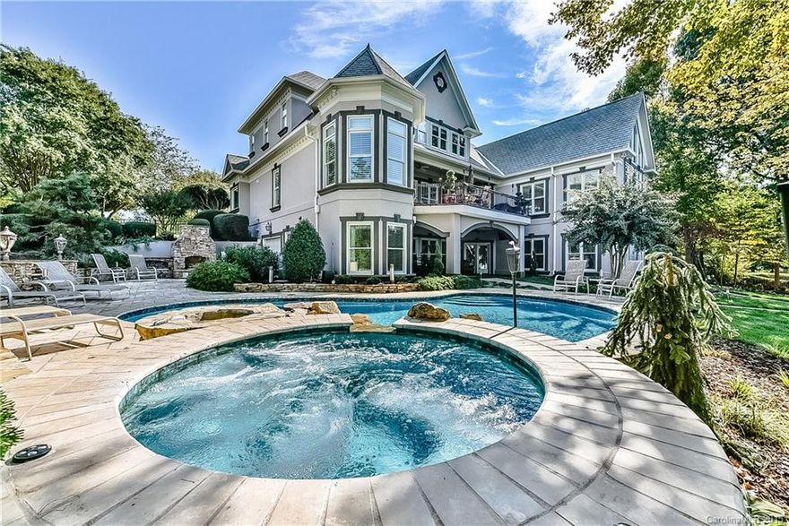 Spectacular waterfront custom built estate in The Peninsula. Amazing views of Lake Norman and The Peninsula Golf Course. This home has 3 levels of living with over 7,000 sq ft and plenty of storage. Private Pier and dock along with custom salt water pool, hot tub, putting green, dockside bar, and an outdoor kitchen with stone fireplace. Master on the main with an unbelievable custom built walnut closet. Large kitchen with granite counters, Viking appliances and travertine floors. 4 car garage!!!