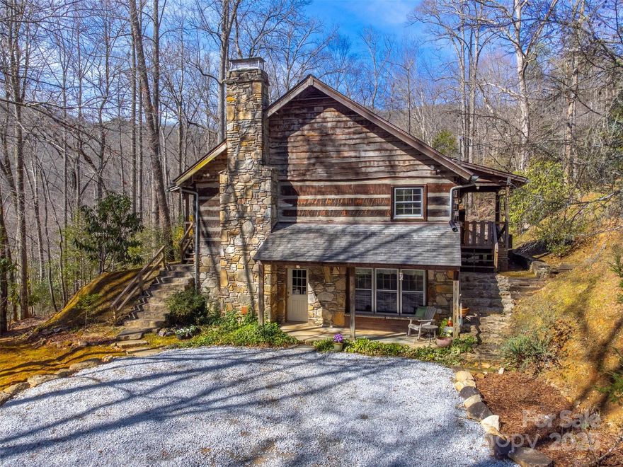 This stunning Appalachian dove tail log cabin is a true gem! Privately situated on 1.48+/- acres, the a large flat backyard for play or entertaining. Inside, you’ll be greeted by soaring cathedral tongue-and-groove ceilings and wide-planked hardwood floors that set the tone for rustic elegance. The open living, dining, and kitchen area is anchored by a striking stone wood-burning fireplace — the perfect gathering spot on cool mountain evenings. The main level features two generously sized bedrooms, while a third bedroom upstairs offers extra flexibility for guests or family. The finished basement expands your living space with a large recreation room, home office, laundry area and flex room, ideal for working from home or hosting extended stays. Outdoor living is just as inviting, with a welcoming front porch, a large back deck, and a gorgeous screened-in side porch that allows you to enjoy the fresh mountain air year-round. Located just minutes from both Sylva and Franklin, you’ll be perfectly positioned to take advantage of the area’s best hiking, biking, kayaking, and fishing. This property is a dream for both adventurers and those seeking a slower pace of life.