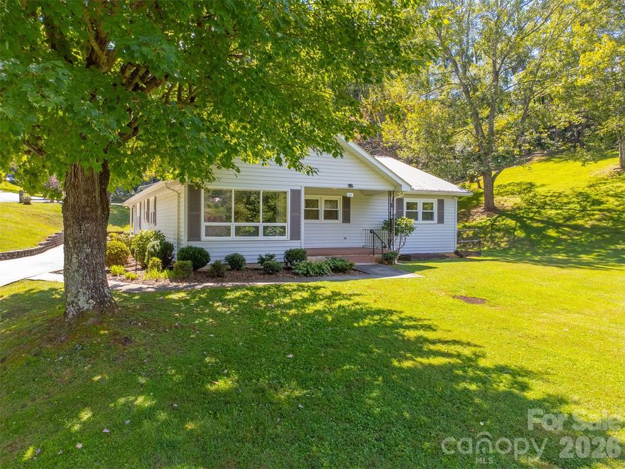 This mid-century home is ideally situated within the Sylva city limits and located on 1.8 acres zoned High Density Residential, offering exceptional flexibility for homeowners, investors, or future development. Comprised of four separate lots, this property presents a rare opportunity for potential expansion, additional homesites, or other residential development possibilities. The existing home offers comfortable one level living with 3 bedrooms, 2.5 bathrooms, a dedicated office, and a basement, making it ideal for those who need space or work from home. The property combines the feel of privacy and room to spread out with the convenience of in town living close to shopping, schools, and restaurants. A detached carport and workshop add functionality for hobbies, storage, or projects. Whether you’re looking for a move-in ready home with character, an income opportunity, or a property with valuable high density zoning and room to grow, this is a unique find within the Sylva city limits.