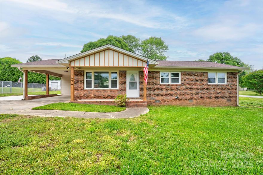 Welcome to this beautifully updated 3-bedroom, 1-bath home on a .45 corner lot that perfectly blends charm and functionality. Enjoy relaxing mornings on the inviting covered rocking chair front porch.  Features an attached carport with an additional parking pad—ideal for multiple vehicles.  Step inside to discover a freshly updated interior featuring new replacement windows, plantation blinds, and stylish finishes throughout. The renovated kitchen is a standout, showcasing granite countertops, black stainless steel appliances, a center island, and ample cabinetry—perfect for the home chef. The updated bathroom offers a modern feel with tasteful upgrades.  Out back, a spacious deck provides the perfect spot for outdoor dining or entertaining. A wired storage building/workshop with its own carport adds even more convenience and utility.  This move-in ready gem offers the best of both comfort and curb appeal—don’t miss your chance to make it yours!