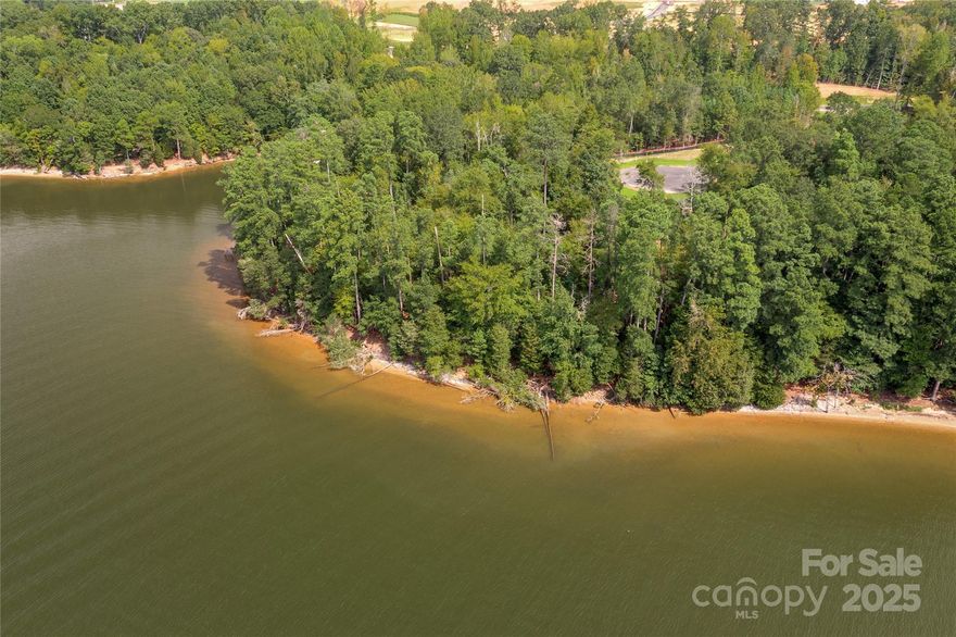 Premier waterfront community on Lake Wylie in Belmont NC. Homesite 3 features stunning main channel views facing south and capturing the eastern and western sun as well. Located on a short cul-de-sac street, this is a serene location. Homesite 3 can accommodate a boat dock with your permit from Duke Lake Management at the time you build your home. McLean features exceptional approved builders who can bring your desired home design to life on this beautiful homesite. Once you purchase the homesite, there is no time limit in which you are required to start building a home, so the timing is flexible to your needs! McLean is located in an amazing spot that is quiet, yet so close to so much! Love small town living and casual downtown vibe when you visit the quaint town of Belmont NC - only about a 10-minute drive from McLean. Enjoy Stowe Park in the center of Belmont, or  coffee at Everyday Market, watch the train go by, play/jog/lounge at the park while listening to the fountain on sunny days, or meet friends for dinner at any of the great restaurants in town. Take in all that Uptown Charlotte has to offer in restaurants, theater, sports, and other events - just 30 minutes away. Travel far and wide for work or play - the Charlotte Douglas international airport is only 20 minutes away and you don't even have to get on the highway - YAY! Homesite 3 is a NC address at the street and the section of the lot at the lake is located in SC. Taxes will be paid to each state based on the amount of land and improvements added in each space. Premier waterfront living is featured at McLean South Shore, the preeminent community within McLean. Let's talk this homesite and take in the views!