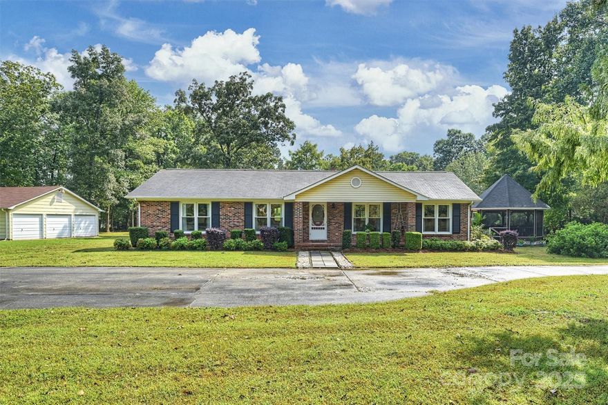Well-maintained single-family home on 3+ acres in convenient location. Enter the circular driveway and you will notice the peacefulness of the setting. Light-filled home provides an open living area and dining room perfect for entertaining. Large, well-designed kitchen was renovated in 2019 with expansive granite counter tops and cabinet storage. Light, airy bedrooms with hardwood floors with ample closet space. Primary bathroom features built in shelving and two vanities. Relax in nature on the back deck or in the screened in gazebo. Land is a gardener’s paradise with endless possibilities. Four car carport and expansive 918 sf garage that can be used for as storage, workout area, workshop or a combination of uses. Property near Springfield Town Center with grocery store, restaurants and a variety of businesses. Privacy of a large lot with nearby amenities 5 minutes from the Carowinds Blvd exit off of I77. City water and septic tank. Residential deed restriction overrides UD zoning