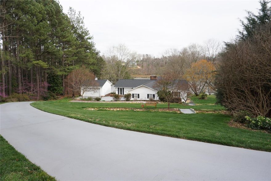 This 3 bedroom features 1.07 acres and is ideally located on Moss Lake.  Enjoy the views from the expansive second floor balcony.  Large bedrooms come with waterfront views.  Cathedral ceilings provide for a wonderful and light living room.  Beautiful landscaping surrounds the home. Ornate fireplace both upstairs and down, that provide a conversational piece.  Additional parking with a covered carport, large driveway and two car detached garage!  Easy access to recreational water activities via the stationary covered boat dock with lift.