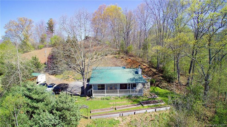 Enjoy the pictorial mountain views from this 2BR 2BA home with additional sleeping loft /office  This Mini farm has vaulted ceiling, stone fireplace, oak hardwood floors, spacious kitchen,  maple cabinets, custom lighting, newer appliances, , master and guest bedrooms on Main floor. The outside is just as spectacular with a workshop/garage. wood shed, fruit and nut trees, raspberry and blueberry bushes.  This Is the perfect location only minutes from Burnsville and 35 Minutes from Asheville.