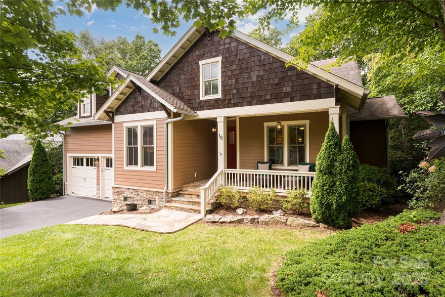 In the heart of Southcliff, Asheville’s premier luxury, nature-focused gated community, this Arts and Crafts residence blends timeless character with modern ease. Set on a beautifully landscaped corner lot framed by mature trees, hydrangeas and rhododendrons, the home offers a rare sense of privacy just 10 minutes from downtown Asheville. Inside, an open, light-filled floor plan connects living spaces with understated elegance. The main level features three bedrooms, a private office, and a thoughtfully designed kitchen that balances beauty and function, along with convenient main-level laundry. Screened porches extend from the dining area and primary suite, creating serene spaces for morning coffee or evenings surrounded by forest sounds. The lower level invites relaxation and entertaining with a spacious family room, guest bedroom and full bath. Outdoor living shines with a screened porch, stone fireplace, hot tub, and fenced backyard ideal for pets or play. Southcliff residents enjoy miles of trails, firepits, pavilions and preserved green space, all within a 24-hour gated community. This refined home captures the essence of mountain living, private, elegant, and deeply connected to nature.