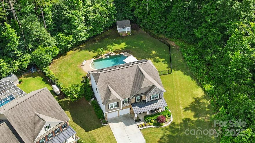 Stunning 5 bed, 4.1 bath Cul-de-Sac Home with Private Poolside Paradise in Highly Sought-After Neighborhood.  Soaked in natural light, this open-concept home features a chef’s dream kitchen with double ovens, luxury fridge, oversized island and white quartz countertops.  The second floor has 4 Bedrooms, all with walk-in closets, including dual primary suites. The third floor includes a bonus area, another bedroom & full bath. Enjoy your backyard oasis complete with a custom gunite PebbleTec salt water pool with waterfall, 7 person hot tub, covered gazebo area and stone fireplace all situated on an oversized patio with plenty of room for entertainment. The backyard also has plenty of green space and a shed for all of your pool toys. Eco-conscious buyers will also appreciate the owned solar panels, delivering substantial savings on electricity cost but not visible to the road. Neighborhood trails and pool close by! Conveniently located near Downtown Kannapolis, Davidson, & Huntersville.