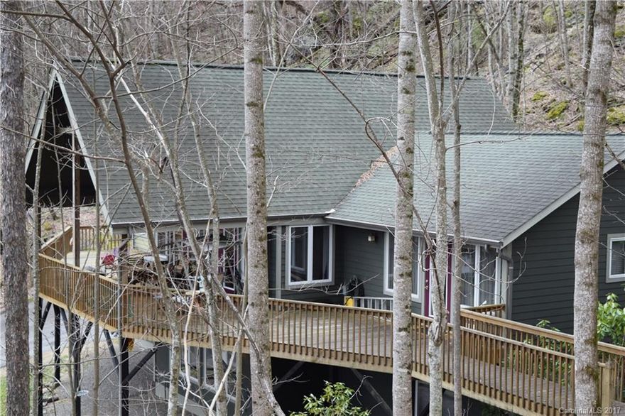 Extremely will kept arts and craft home with year round view and privacy in a popular community. All bedrooms are private from the others. Open floor plan open to a large deck with the view. Call it a cabin/cottage in the woods. Fireplace up and down. Big play room with fireplace and pool table. Yard has no grass to cut. just some small weed eating. Downstairs stairs great room has sink, refrigerator and wine cooler and Pool Table.