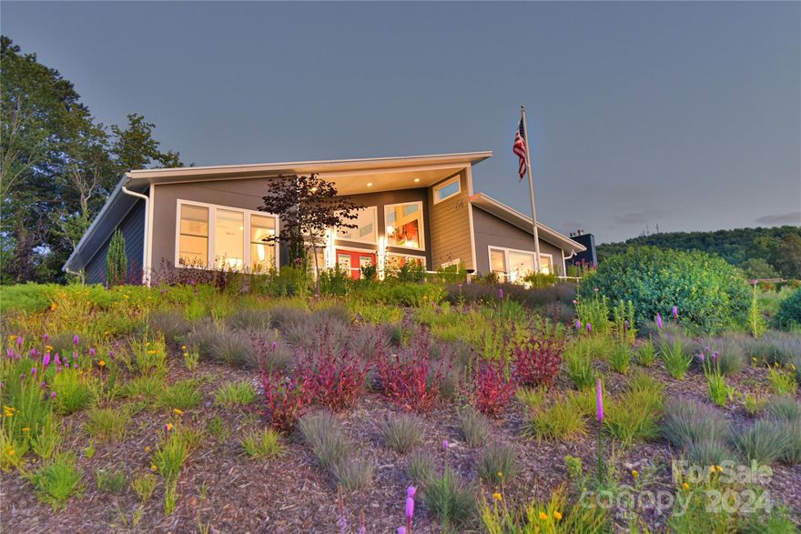 This custom-built home marries modern design with the most comfortable of living conveniences. Zero entry from two-car garage through every room in the house. The open floor plan offers amazing views from the great room and two of three bedrooms. Solar panels offer very economical living in the all-electric home. There is even a car charging station in the garage!
As you approach the home, you will notice a beautiful, wildflower meadow in front of the home. This is a Certified Wildlife Habitat with flowers blooming through different seasons. You have to see this home in person to take it all in. Easy living, low utilities, great views! This is the total package! Make it yours today.