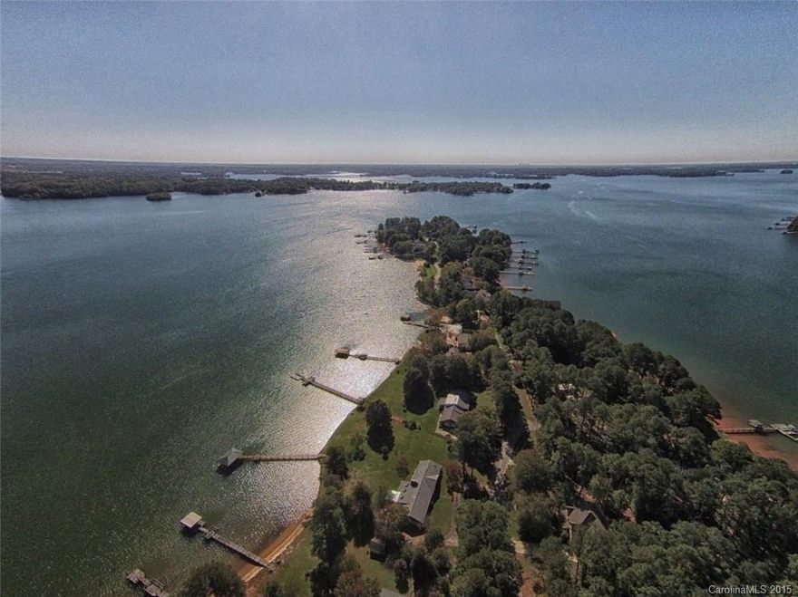 Highly desirable Isle of Pines peninsula on Lake Norman.  This waterfront lot, 1 of 3 available, could be combined with 2 other adjacent lots for larger building envelope. Level flat lot boasting original pines, defining the name Isle of Pines. Seawall and natural beach area. Amazing sunset views. Please limit showing to 8am-8pm.