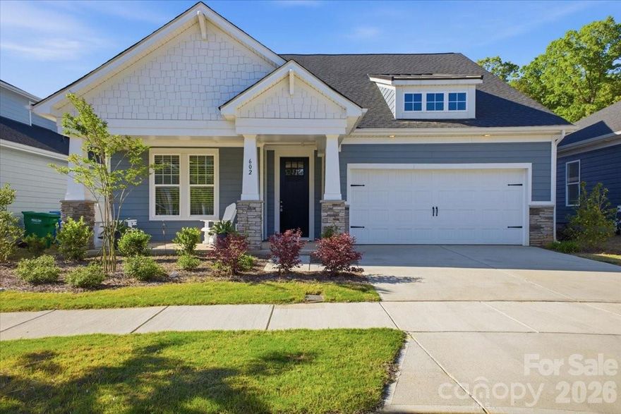 Why wait for new construction when this stunning 2025 Watts plan is ready now — with all the upgrades already done for you? Nestled in the sought-after Terraces community in charming Cramerton, this immaculate ranch home has been lovingly maintained for just one year and shows like a model.
From the moment you step inside, the attention to detail is unmistakable. Crown moulding frames the open living spaces, where luxury vinyl plank flooring flows seamlessly into a showstopping kitchen featuring 42" white cabinetry, calcatta lazza quartz countertops, a herringbone tile backsplash, and a full suite of stainless steel appliances including a gas range. The flat-top island overlooks a generous great room anchored by a cozy gas log fireplace — ideal for entertaining or quiet evenings at home.
The spacious dining room offers plenty of room for a full-size table, making everyday meals and holiday gatherings equally comfortable.
Retreat to the private owner's suite, where the split-bedroom layout ensures peace and quiet. The ensuite bath is a true sanctuary with a double vanity, quartz countertops, a tiled walk-in shower, a separate water closet, and a generous walk-in closet. Two additional bedrooms and a full bath round out this thoughtfully designed floor plan.
Outside, enjoy a covered front porch, concrete patio, and a 2-car garage — all with sidewalks and street lights throughout this welcoming community conveniently located minutes from downtown Cramerton and Belmont.