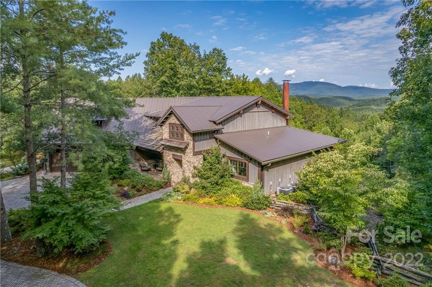 Dreaming of your own one-of-a-kind mountain home in the Blue Ridge Mountain foothills w/natural water sources, extreme privacy, & gorgeous long-range views where you can escape from the world into your own secluded retreat?  Nestled amongst 20+ acres w/incredible views of Craggy Pinnacle, Mt Mitchell, & Hickory Nut Gorge, the exterior is clad in a warm mix of cedar shakes & metal roofing, board & batten siding & stone.  Massive reclaimed heart pine timbers, oiled Mankato & Tigerwood floors, concrete countertops, & a steel staircase bring unparalleled warmth to the interior.  Over 1200sf of covered porches, custom fireplace, pizza oven, grilling bar, & sliding windows connecting the chef's kitchen to the outdoors.  Mountain views extend through the main level bedroom suite with en suite bath that's to die for.  You'll love the large unfinished basement, oversized drive-through double garage w/work area & no-step access to the front & rear yards as well as the back porch.