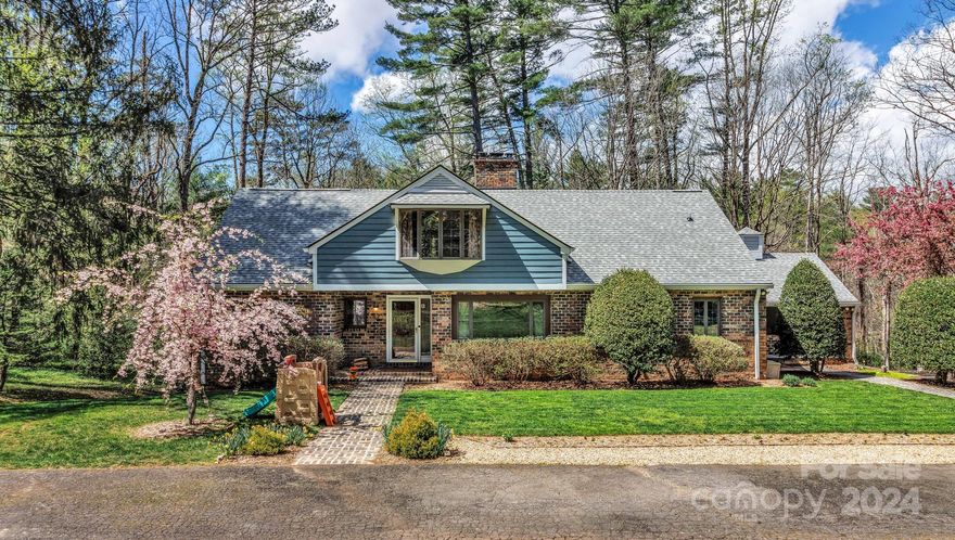 Beautiful 2-story home w/ basement in coveted Biltmore Forest! Tremendous price and value for the size of this home. The lot is large, sunny and very usable, its gorgeous! This 4-bedroom, 4.5-bath estate is nestled on nearly 2 acres w/ a beautiful level front yard, covered front & side porch, & a huge deck overlooking the serene backyard. Inside you'll find tremendous usable spaces w/ a large front-facing living room w/ wood-burning fireplace, breakfast room w/ access to deck plus a bonus room that makes a fantastic office or playroom. The kitchen has stainless steel appliances, kitchen island, breakfast bar, & beautiful granite countertops. Large primary suite on upper level includes walk-in closet, attached sitting/dressing room, & a bathroom w/ dual vanities, walk-in shower, & whirlpool tub. 2nd primary bedroom on main. Extensive storage space in the enormous basement. Highlights include attached 2-car garage, newer HVAC/air handler and community amenities.