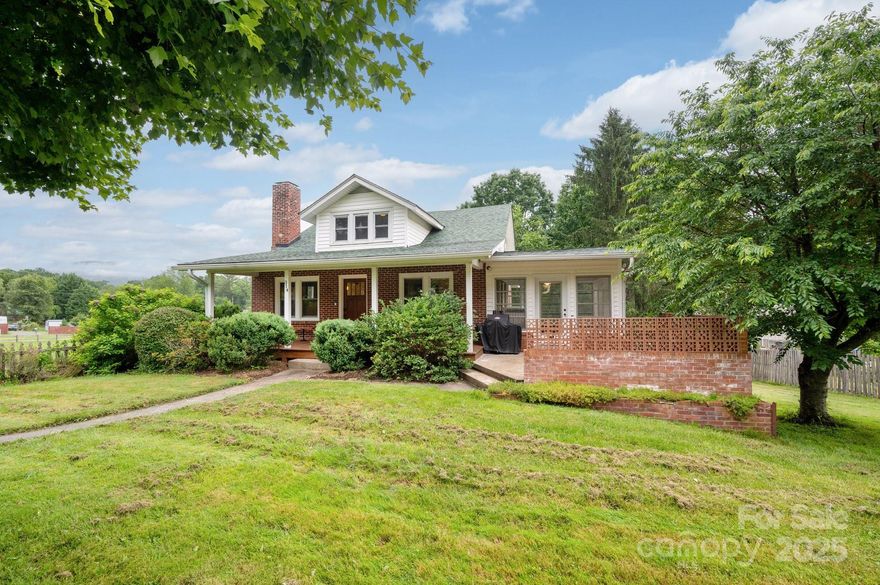 They just don’t make them like this anymore. Only 15 minutes from downtown Asheville, this lovingly-maintained 1930s home offers rare character, original wood floors, crafted details and finishes, and traditional warmth and charm. Set on a generous, beautifully landscaped lot with fruit trees, flowers, and a “mountain flat” fully-fenced back yard, there’s plenty of space for whatever you envision. Need room for projects? You’ll love the large, lofted garage, which offers great potential for a workshop, studio, or additional storage. The heated, unfinished basement also provides ample space for hands-on hobbies or future expansion, and is plumbed for a bathroom. A small outbuilding out back is ready for chickens or gardening gear. Whether you’re drawn to its character, its setting, or its possibilities, this home is a rare find.