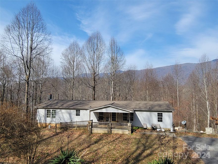 A private 3 bedroom, 2 bath with bonus room approximately 1800 sq ft home with a full unfinished basement has just become available. Gorgeous setting on 5 wooded acres. Homesite is open to full sunshine. There are additional homesites available on the property. Located 9 minutes from Downtown Waynesville. 10x24 covered deck facing views of the Parkway. Also has an 8x18 front covered deck. This home will not last long.