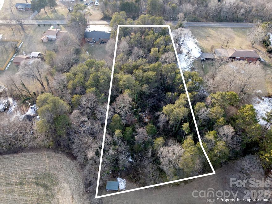 Great lot in Statesville convenient to so many things and quick access to I 40 & I 77.  Two parcels being sold together totaling 1.3 acres!  Currently all wooded both lots are adjacent to each other with one behind the other making a deep lot about 400 feet so plenty of room for front yard, back yard, outbuilding etc.  Located just outside of the city limits and in the city's ETJ yet not currently within the city limits makes it short drives all around town to grocery shopping, restaurants, other shopping, businesses, doctor's offices, Downtown, and many other things.  It's also just down the road from the Iredell County Agriculture offices, Public safety offices, and the Iredell County Animal Shelter.  There is also quick access to the Statesville Airport.  County/city water & city sewer are not currently available at the property, but plenty of room to have a well & septic installed.  Here's the chance to build that new home and actually have a nice sized yard!
