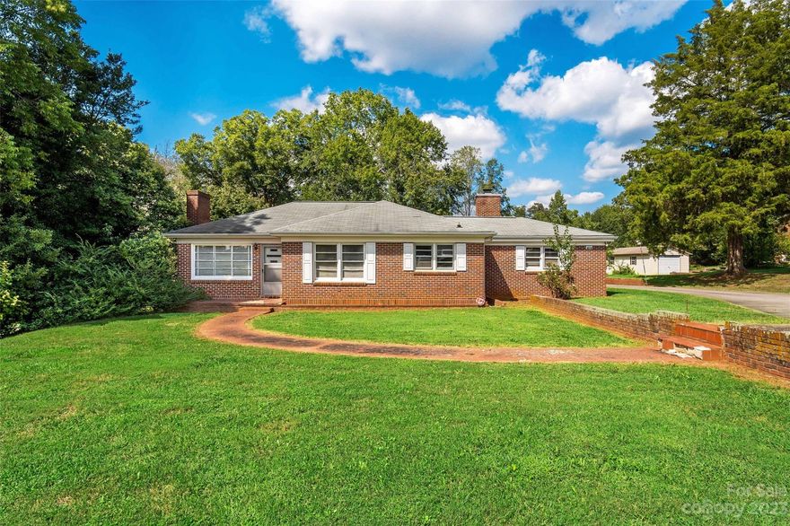 Nestled in the idyllic countryside of Catawba County, this charming 1955 brick ranch home offers a delightful immersion into the beauty of country living. With two generously sized bedrooms and a full vintage-inspired bathroom, the home boasts remarkable vintage details that transport you to a simpler time. Awaiting your personal touch, this well-constructed residence stands as a blank canvas, ready for cosmetic updates that reflect your individual style. With two detached garages, you will have abundant storage & workspace opportunities.Please note that the sellers will not be making repairs, granting you the liberty to craft a space that resonates with your vision. Adding to its allure, the property comes with an additional 8 adjoining acres of gently rolling, cleared land. This expansive acreage opens up a world of possibilities, whether you envision creating a mini farm or expanding your family's living space.