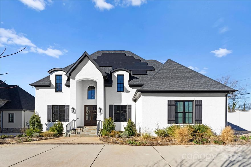 Exquisite, modern custom home in PRIME South Charlotte location! Main level boasts the ideal open concept with gorgeous Chef's Kitchen featuring quartz counters, a Café four-door refrigerator, dual Dacor ovens, a Dacor range, a pantry, and a Butler's pantry with a built-in dual-zone wine fridge. Light filled living room leads to a private backyard, allowing for dual indoor/outdoor living. Large main level Primary Suite with a walk-in closet and an impressive ensuite bath with Carrara marble with deep soaking tub and over-sized shower. The upper level has 2 additional bedrooms plus a guest suite with an ensuite bath and two walk-in closets. Entertainment room can also be used as a fifth bedroom. This Energy Efficient home is powered by solar panels and over 24hrs of back-up battery power, has two tankless water heaters, electric car charging port, security system and a full yard irrigation system. Covered back porch overlooks newly built saltwater pool with a jet water feature!Come see!