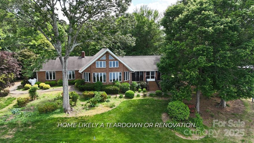A rare opportunity awaits on this incredible 0.95-acre waterfront lot with sweeping, mile-long views of Lake Norman in multiple directions. With 360 feet of shoreline lined entirely with rip rap, this property stands out as a prime location to build your dream home. Unlike many lakefront lots, this one has CITY WATER AND SEWER AVAILABLE AT THE STREET, giving you the freedom to expand your building plans without the limitations of a private system. But that’s not all—this lot also includes a covered dock and a private boat ramp, making lake access easy and enjoyable. While there is an all-brick home currently on the property, it’s likely best suited for a major renovation or teardown. For those considering a remodel, measurements and additional details about the existing structure are available. The current home is on a private well and septic system. Don’t miss this chance to own one of the most impressive lakefront lots on Lake Norman.