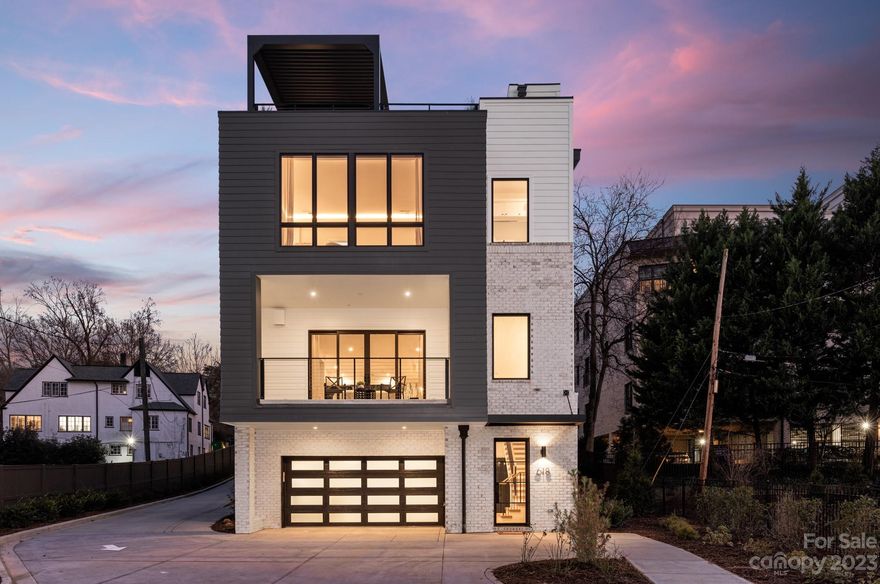 Prepare to be wowed by this spectacular new construction end-unit condominium in Myers Park! A modern showstopper, this home features a private elevator accessing all levels, a 2-car garage and an 824 square foot rooftop terrace with motorized pergola and views of Uptown Charlotte. Sophisticated modern finishes are found throughout, from the white oak hardwood floors to the Wolf and Sub-Zero appliances. You'll appreciate the light, airy feeling that envelopes you courtesy of oversized windows on 3 sides of the residence. If the evolution of your life has you desiring privacy, ease, and a chic space to welcome family and friends, this residence will fulfill your every need.