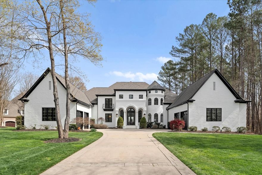 A truly stunning architectural masterpiece, 9000 Mystic Point Ct is located in the amazing town of Belmont. As you drive through the gated entrance of Woodland Bay, you'll instantly feel at home in this exclusive community nestled in a wide bay on Lake Wylie. This magnificent home boasts 4 BR, 5 full BTHs, and 2 half Bths, with 7,120 square feet of finished living space and a partially finished lower level with a bathroom offering an incredible value-add opportunity! Built like a fortress, this home was custom designed boasting huge rooms, modern furnishings, and 4 fireplaces throughout the home. The upper level offers two large ensuite bedrooms, a theater, and a bonus room with a bar. The main level boasts cherry floors, granite countertops, and beautiful finishes throughout, while the covered porch facing the lake and your boat slip is the perfect place to unwind after a long day.
Perched on Lake Wylie, you’ll enjoy endless serenity while having easy access to nearby necessities.