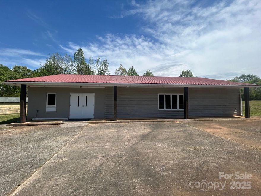 Large level 2.22 acre lot in the county that has a large 60x36 building. The building has been renovated with new lighting, new kitchenette, updated bathrooms, new doors, new HVAC, exterior and interior painting. This property is fenced. Plenty of space for parking & the space to create extra storage.