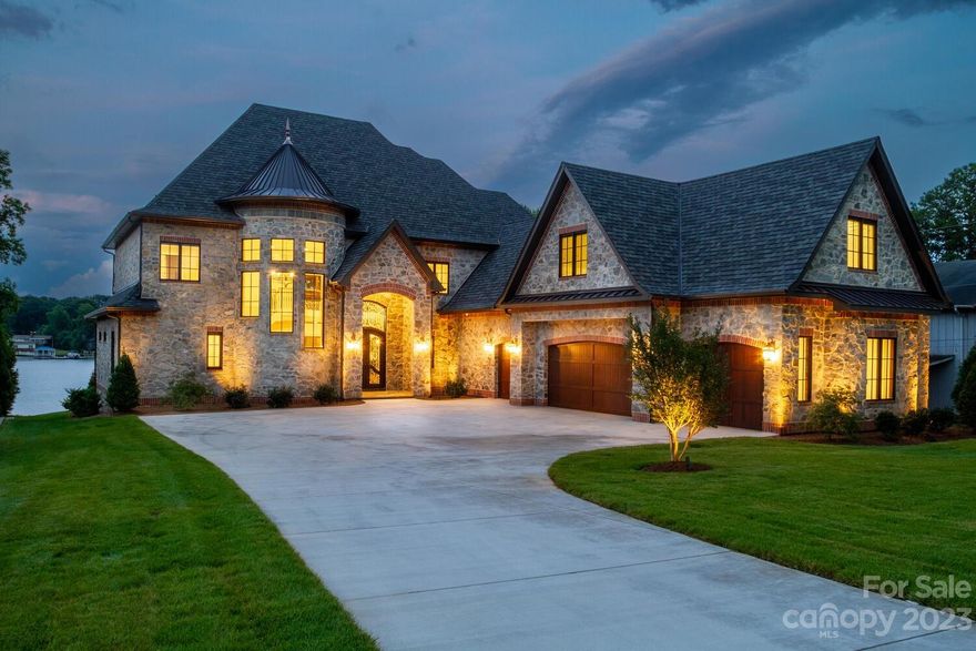 Exceptional newly completed waterfront residence by Stonebridge Luxury Homes. This full stone and brick home features a 13ft wrought iron front door, oversized 4+ car garage and covered rear patios. No expense spared or detail overlooked. From the magnificent master suite to the chef's kitchen to the extensive trim and woodworking details, this home exceeds expectation. Nearly too many details to list, see dedicated feature list and brochure in attachments. Home can be used for rental and can accommodate a pool. Septic in front yard.