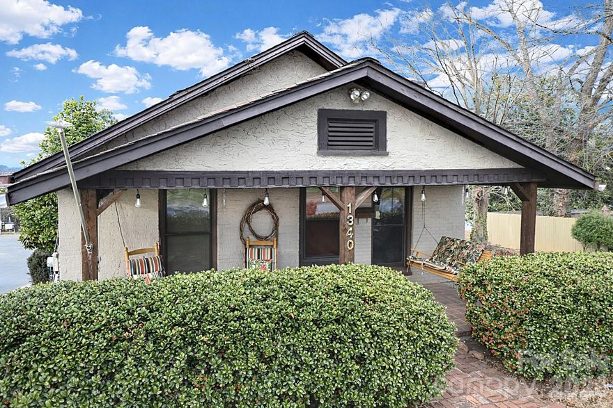 This "Cute as a Button Bungalow" is located in Hickory, near the new City Walk. You can reach downtown in just a few minutes and have easy access to Highway 321, shopping, and more. This home sits on a corner lot and has a convenient drive-through driveway, allowing parking under the spacious back deck. The beautiful landscaping adds charm, and the covered front porch is perfect for enjoying your morning coffee. The back deck steps lead to a nice yard and an unfinished basement with a shop for extra storage. Inside, you will find a spacious living room and dining area with a cozy window seat and a wood stove. The home has two bedrooms and a bathroom, all featuring beautiful wood floors. The kitchen and mud room are conveniently located near the back deck, making it easy to entertain guests. This home has a wonderful vibe and plenty of charm throughout. Don't miss your opportunity to own this delightful space that feels warm and welcoming!