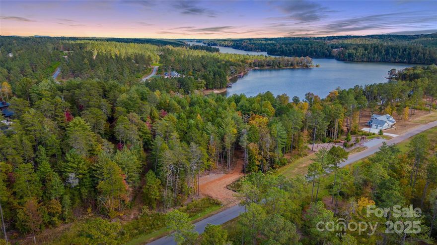 Bring your own builder! Welcome to The Waterfront Club, a premier gated community on Lake Rhodhiss in Granite Falls, NC! This 1.21 acre build-ready lot features a pre-built driveway and peaceful water views - offering the perfect setting for your dream home! This particular lot is steps from the community playground and kayak launch! Other community amenities include a waterfront pavilion, private community dock, clubhouse w/ outdoor pool overlooking the lake, a sandy beach area, lakeside cabana, & walking trails. Minutes from Castle Bridge Marina! Whether you envision a year-round residence or a weekend retreat, this property combines convenience, natural beauty, and resort-style living!