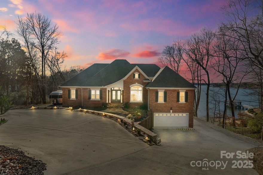 Experience unparalleled lakeside living! This recently updated retreat offers expansive lake views from almost every room. Large windows offer abundant natural light. Boasting two main-level primary suites, this home provides comfort and privacy for all. The spacious kitchen features a large island, gas range, beverage fridge, and gathering spaces. Expansive Trex deck to enjoy sunset lake views. Finished walk-out basement is an entertainer’s haven, complete with a bar and game room, tons of storage, full bath, and bonus room could be 5th bedroom. The fully finished oversized 2-car garage offers additional storage. Outside has everything you need - enjoy a dedicated pad for your RV/trailer, outdoor grilling/dining area, covered patio with hot tub, fire pit, shared beach area, and stationary Trex covered dock with boat lift and jet ski ramps. Great Mooresville location with no HOA. Don’t miss your chance to own a slice of lakefront paradise! This home could be sold fully furnished.