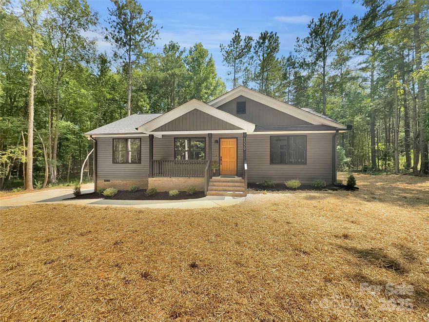 Brand New construction home on over an acre of wooded land in the Buford School District, just minutes from Waxhaw, NC too! This Beautiful home offers a great split bedroom floor plan with an Open Concept living area. As you enter from the welcoming Covered Front Porch you'll notice the lovely Laminate floors throughout and the vaulted ceilings in the living area. The kitchen offers bright White Soft Close Cabinets, Lovely Quartz counters, and Stainless Steel Appliances. Next to the kitchen is a designated Dining Area, Laundry Room, and access to the Large Rear Deck overlooking the wooded back yard. The Primary Suite has a spacious bedroom and Primary bathroom with Dual Vanity, Quartz Counters, Tiled Shower surround, and Large Walk-in Closet. The 2 secondary bedrooms are on the opposite side of the home and share a 2nd Full Bathroom that also has Quartz counters. The 1.24 acre wooded lot gives the home a nice private setting with plenty of trees.