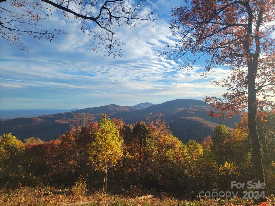 Corner lot with rare flat-to-gently sloping buildable area at over 3,000 foot elevation! You will never want to leave your mountain home with these spectacular 50-mile layered mountain views overlooking the Pisgah National Forest and South Mountains State Park from this 10+ acre parcel. Located in a quiet, gated neighborhood with community walking trails and well-paved roads - Buried electric/underground utilities.  A beautiful, picturesque 20 min drive to the quaint town of Black Mountain and 30 min to Asheville. Watch the seasons change and enjoy the refreshing mountain air from your very own slice of heaven!