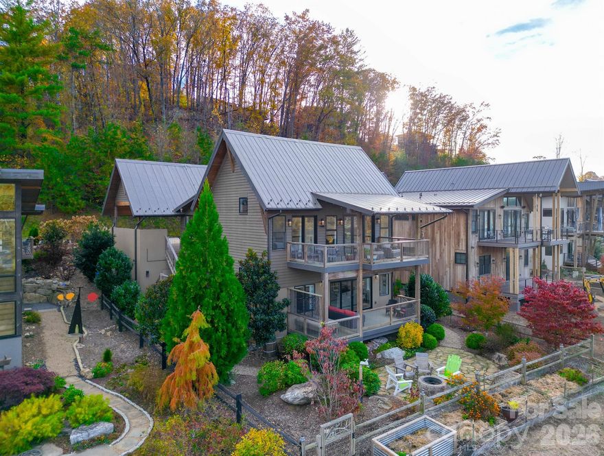 Boasting one of the most breathtaking views of the French Broad River in Asheville, with community access to the river, this beautifully designed 2,331 sqft home perfectly blends modern comfort, energy efficiency, and a peaceful connection to nature. Nestled within Asheville’s most inspired agrihood community, residents enjoy scenic walking trails, community gardens, river access, and mountain vistas — a lifestyle deeply rooted in both sustainability and community.

Step out onto the back deck and take in the serenity! You’ll hear nothing but the gentle flow of the French Broad River below and the rustle of leaves in the breeze. Homes in this community have thoughtfully planned geothermal HVAC systems, designed not only for efficiency but also to minimize mechanical noise, ensuring that the sounds of nature remain the soundtrack to daily life.

Recently repainted in full, the home’s exterior offers a fresh, timeless presence that complements its natural surroundings. Inside, the careful craftsmanship continues — featuring a Sonos sound system throughout, heated floors in the primary bathroom, and a jacuzzi tub that transforms everyday moments into restorative retreats.

Efficiency is built into every layer of this home, reflected in its outstanding HERS Rating of 52. The solar battery system, housed indoors for optimal climate performance, offers energy independence and stability. A rainwater collection system supplies nearly all irrigation needs, while propane is used only for the fireplace and water heater, — an intentional blend of sustainability and smart living. Need a place for hobbies? Enjoy the large workshop used for woodworking, storage, or other activities.

From its river-view deck to its energy-wise design, every feature of this home invites you to live with balance, purpose, and quiet bliss.

40 River Run isn’t just a place to live — it’s a front-row seat to the peaceful rhythm of the French Broad River, a thoughtfully crafted retreat that celebrates Asheville’s beauty, community, and spirit of stewardship.