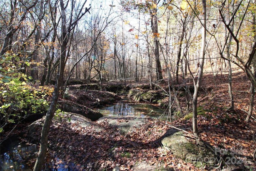Beautiful 40+/- Acre tract of land on a quiet road in Clover SC. Property is surrounded by other large tracts and is convenient to York and Clover. Nice private hilltop build site nestled in the woods overlooking property. Property features a beautiful creek, mature trees and amazing hilltop views. Beavers have dammed about an acre of the creek on the east side creating a pond offering the potential for duck hunting. Enjoy the privacy, abundant wildlife, and hunting opportunities this property has to offer. Minimum deed restrictions to create like in kind properties. Land is part of a larger tract with two separate tax parcels: the front portion being Clover School District and the back portion York School District. CALL LISTING AGENT BEFORE SHOWING PROPERTY, IT IS CURRENTLY BEING HUNTED!!