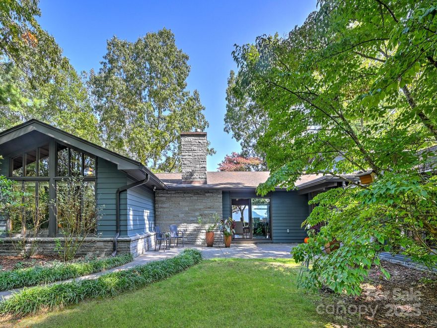 Discover an extraordinary opportunity to own an impressive piece of Asheville architecture.This beautiful mid century masterpiece, a true sanctuary, was designed by architect Anthony Lord, of  the renowned firm, Six Associates. One of Lord’s most notable designs is downtown Asheville’s Citizen Times Building. Framed by clean architectural lines, comprised of stone, steel, glass, and gleaming woods, the flowing main level is open and nestled in lush nature, offering a variety of rooms for living, working and entertaining.The loft area, presently used as an art studio, has an abundance of windows, and is a truly inspiring flex-space.
This legacy estate, thoughtfully placed on over 5.5 acres, affords one the utmost privacy, all the while being minutes from downtown Asheville. Spectacular east facing views from atop Beaucatcher Mountain. 
The exterior of the home was repainted and the gutters replaced at the end of September. Electrical, plumbing, and HVAC have been updated.