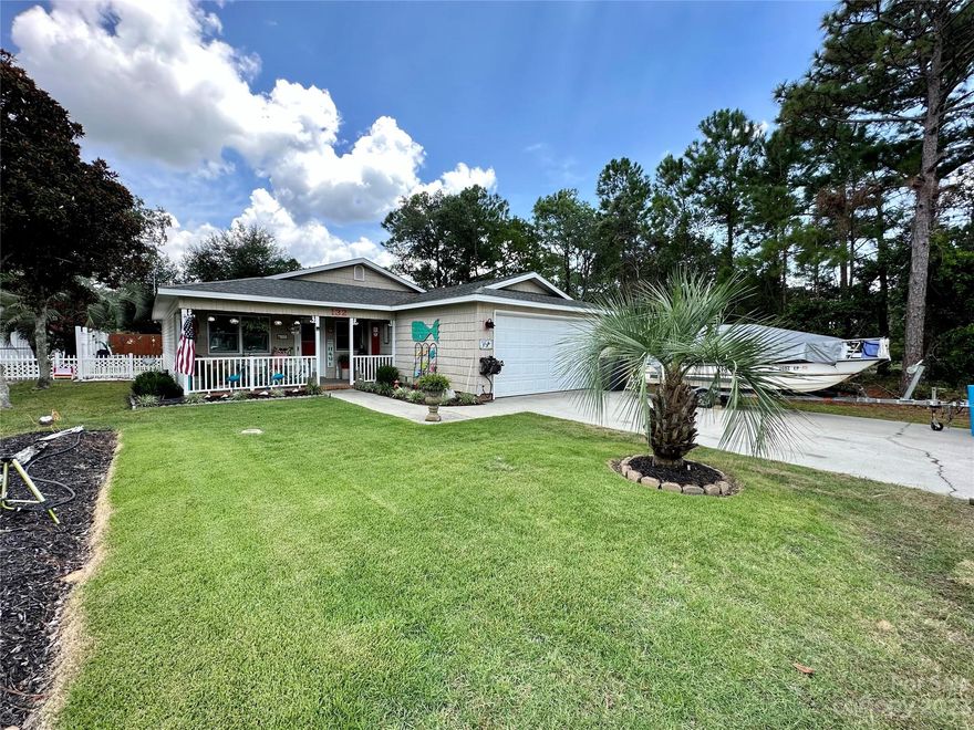 GORGEOUS 3 BR, 2BA home, located less than a mile from the sandy beaches of Oak Island & the inter-coastal waterway! Well maintained, updated, & renovated! This home features a spacious 2 car garage with a built in workbench, 2 pantries, a large flex/bonus space, & fresh paint & brand new flooring throughout. Fully fenced in backyard features a brand new pergola covered patio & a large storage shed. Low maintenance backyard is perfect for entertaining & cookouts! Private outdoor shower is perfect for washing all of the sand off after a fun filled day at the beach! Public beach access parking is free for Oak Island residents with a permit. Street legal golf carts are also welcome! 6+ parking spots in driveway+garage. This close knit community is away from the hustle & bustle of the busier streets, but still conveniently located less than a mile from restaurants, shops, grocery stores, & more! Stackable washer/dryer, kitchen appliances, & storage shed convey. Schedule your showing today!