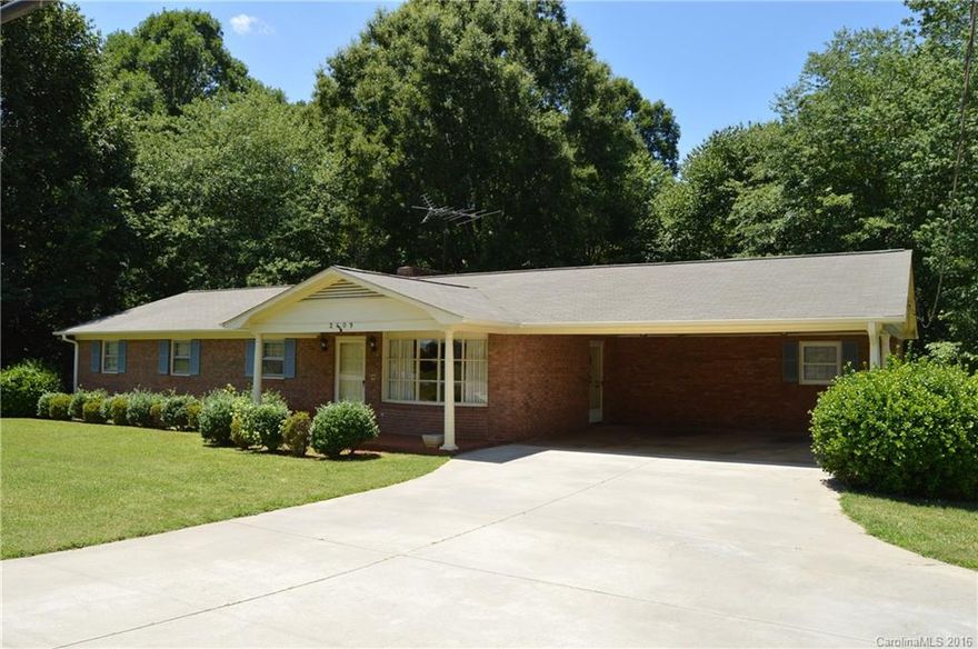 A very nice brick home that sits on 2.4 acres off of East Broad Street in Statesville. This home has four spacious bedrooms with three bathrooms, two full bathrooms upstairs and one full bathroom in the basement. There is hard wood flooring throughout the house with wall to wall carpet in the bedrooms. There are two fireplaces, one on the main level in the den with gas logs, and the second fireplace is wood burning in the basement. There is a utility building located in the rear of the property.