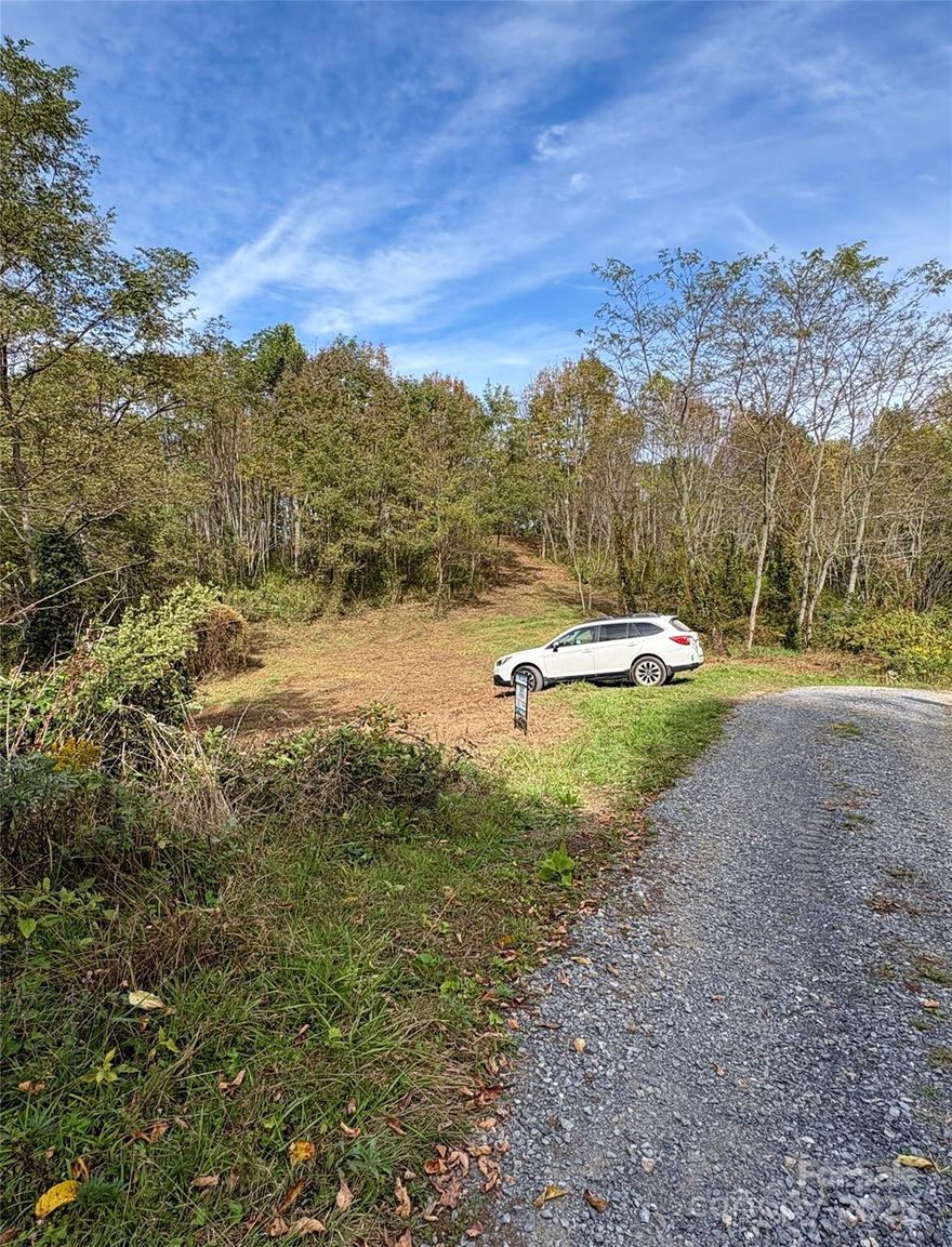 Freshly bush-hogged and cleared for walking! Charter Spectrum Fiber Optic High Speed Internet is now available in this neighborhood! Come spend some time walking this land and become familiar with just how special this property truly is. Easy to walk, rolling land with multiple building spots. Take a short walk to the top of this property for long range, panoramic mountain views. You truly can get gorgeous views without a harrowing drive up the steep side of a mountain. Build your home on the gentle, rolling meadow at the top of the property. Catch stunning sunrises & sunsets without leaving home. Magnificent mountain views in almost every direction with tree removal. Property backs up to Max Patch Rd & the National Forest. Miles of roads, horse trails & hiking trails. Bring your horses, they are allowed here. Hiking, horseback riding & mountain biking are all big activities in this area. Fully enjoy all of the benefits of living in western North Carolina! Only 6.7 miles to Max Patch! Appalachian Trail runs right across the top of Max Patch! This area was filmed in the movie, A Walk in the Woods, with Robert Redford.
30 Minutes to Food Lion in Clyde or 36 minutes to Ingles Grocery in Canton. 37 Minutes to heart of Waynesville
Please be aware -#48 photo is from the lot next door to this lot. After clearing trees, views could be similar per the seller