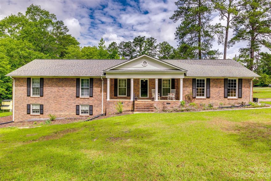 GORGEOUS desirable, ranch style floor plan + basement and garage with neutral finishes! Spacious living room with wood burning fireplace and luxury vinyl plank floors. Kitchen looks out to the dining area and has yards of granite countertop space and white cabinets. Three bedrooms including expansive owner's en suite on main living floor.  Basement level has a half bathroom and can be a bonus or recreation room. Back deck patio off of the living area – perfect for entertaining or enjoying morning coffee! Check out the bonus of a 20x30 storage building with electricity and water hookups.
