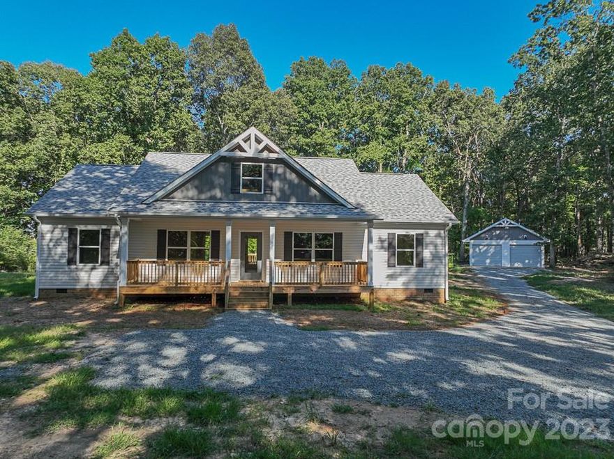 Come see this recently completed new construction home! Beautiful 3 bedroom, 2 bath Ranch home, 1,652 sqft split floor plan home with a 2-car detached garage on 10 acres! Private & Wooded! This is the space you have been looking for! You are greeted by a large, covered rocking chair worthy front porch that leads you right into this open concept floor plan! The kitchen features shaker style cabinetry, granite countertops, whirlpool appliances, LVP flooring and TWO pantry areas! Off the kitchen is a spacious Utility/laundry room with wall-to-wall shelving. The master bedroom has a trey ceiling and linen closet. The master bath has a double sink vanity with a makeup counterspace, a large drop-in garden tub and separate shower with a spacious walk-in closet as well. Leading outside from the kitchen/dining area is a wood deck, giving plenty of room for grilling and entertaining! Schedule you're showing today, this one won't last long!