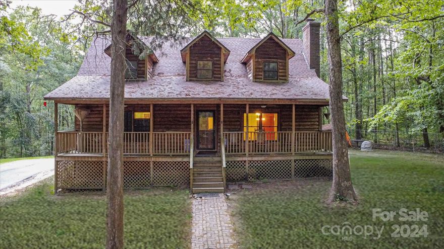 Nestled on a serene 2.5-acre wooded lot, this charming cabin offers rustic charm and modern convenience. Just minutes from town, it provides a tranquil escape with all the amenities you need for a comfortable lifestyle. Enjoy beautiful views from the front porch and back deck, where you can relax and take in the natural beauty. The cabin is bordered by a gentle creek, adding to the serene atmosphere. The living room features a cozy wood-burning fireplace, perfect for chilly evenings. The kitchen boasts stainless steel appliances, ample counter space, and a spacious island. The primary bedroom offers an ensuite bathroom with a luxurious clawfoot tub. Additionally, the property includes a storage building wired with electricity and a zipline for fun and adventure! Whether you're looking for a peaceful retreat or a place to entertain, this property offers it all. Don't miss the opportunity to make this cabin your own!